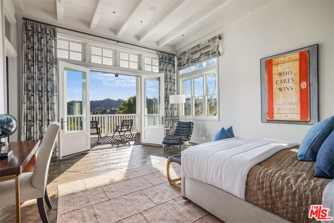 9779 Oak Pass Road Beverly Hills, CA 90210 - Photo 26 of 43 a bedroom with a bed and a large window