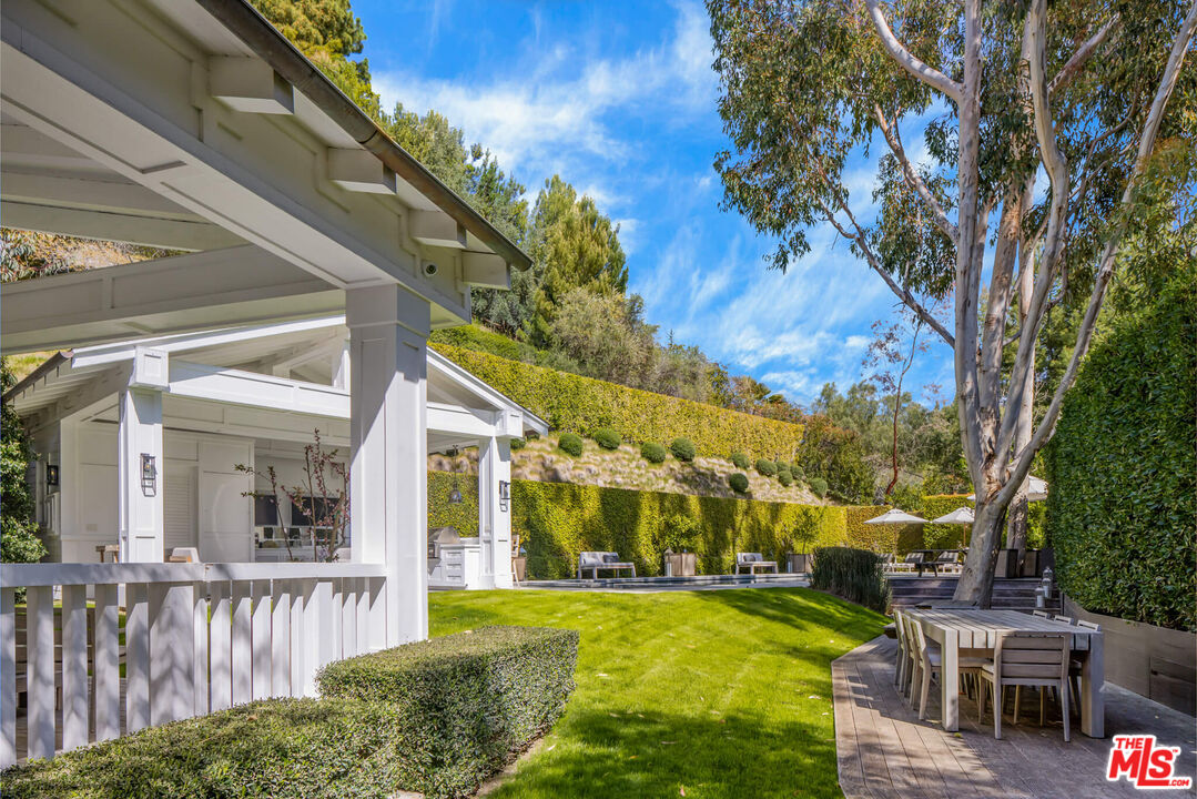 9779 Oak Pass Road Beverly Hills, CA 90210 - Photo 29 of 43 a view of a house with swimming pool and sitting area