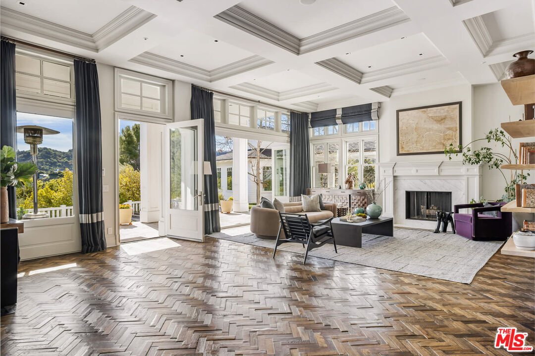 9779 Oak Pass Road Beverly Hills, CA 90210 - Photo 3 of 43 a living room with furniture large window and a fireplace