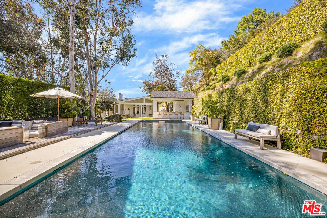 9779 Oak Pass Road Beverly Hills, CA 90210 - Photo 31 of 43 a view of a house with pool and sitting area