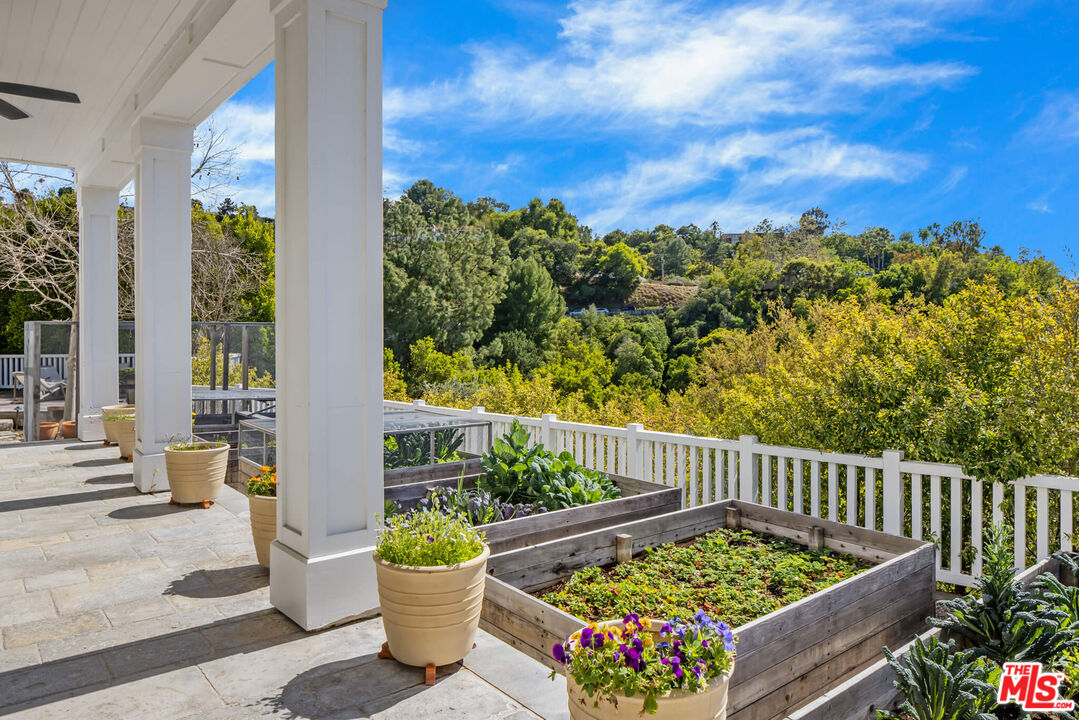 9779 Oak Pass Road Beverly Hills, CA 90210 - Photo 33 of 43 a view of a chairs and table in patio with potted plants
