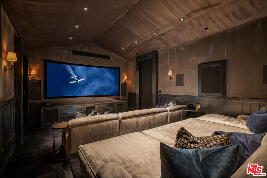 9779 Oak Pass Road Beverly Hills, CA 90210 - Photo 38 of 43 a living room with furniture and a flat screen tv