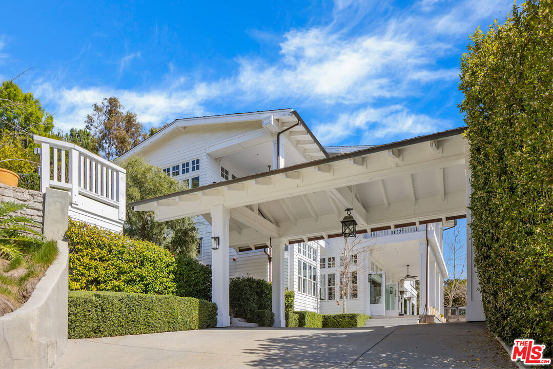 9779 Oak Pass Road Beverly Hills, CA 90210 - Photo 42 of 43 a front view of a building with a garden