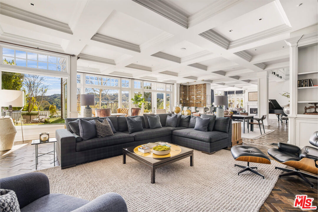 9779 Oak Pass Road Beverly Hills, CA 90210 - Photo 8 of 43 a living room with furniture a rug and a large window