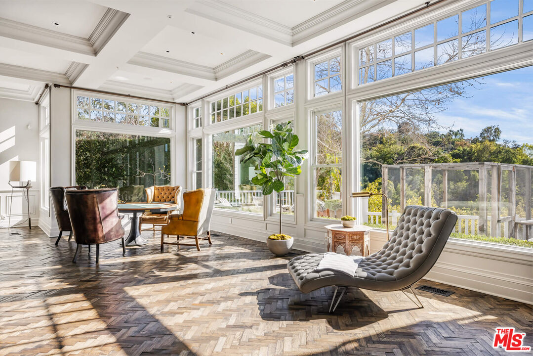 9779 Oak Pass Road Beverly Hills, CA 90210 - Photo 9 of 43 a living room with patio furniture and a floor to ceiling window