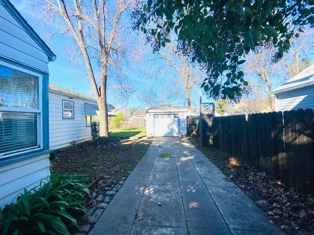 a view of a pathway of a house with a yard
