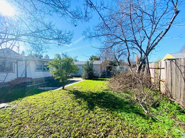 a view of backyard with swimming pool