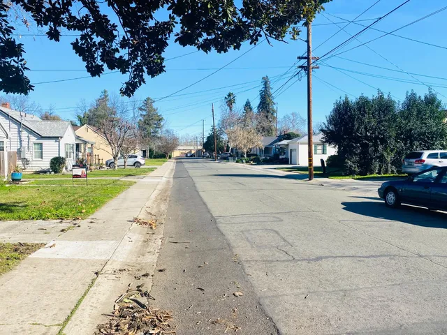 a view of a street with a building and a street sign