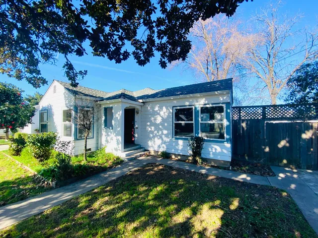 a front view of a house with a yard and outdoor seating