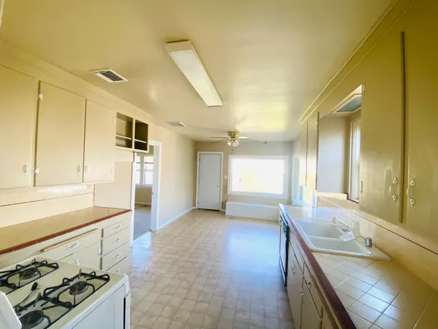 a kitchen with stainless steel appliances granite countertop a sink and cabinets