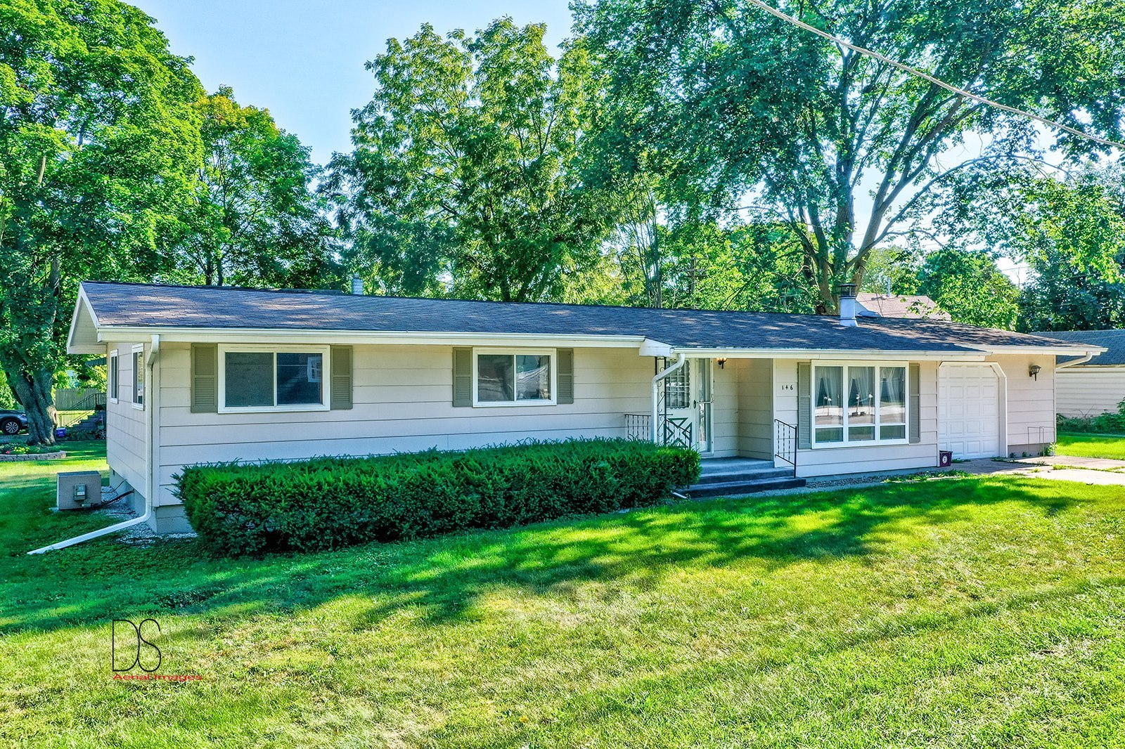 a view of a house with a yard and a garden