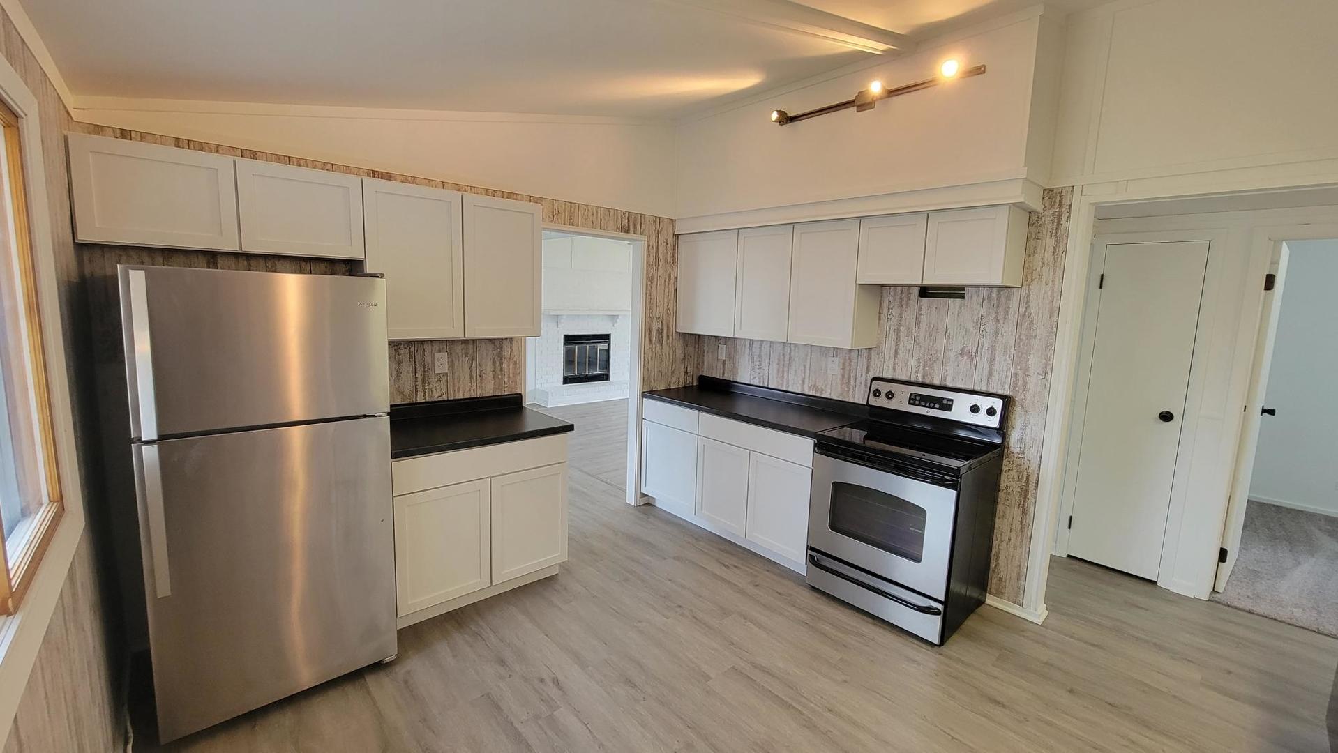 146 Center Street Seneca, IL 61360 - Photo 4 of 19 a kitchen with stainless steel appliances a refrigerator a sink and white cabinets