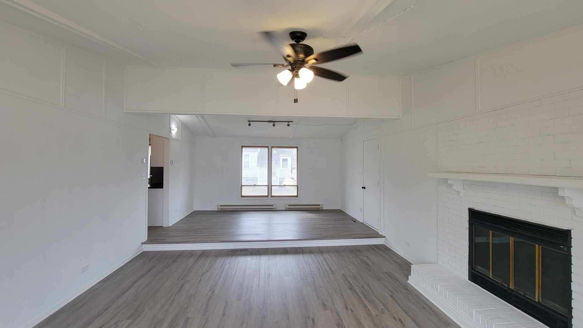 146 Center Street Seneca, IL 61360 - Photo 8 of 19 a view of empty room with wooden floor and fan