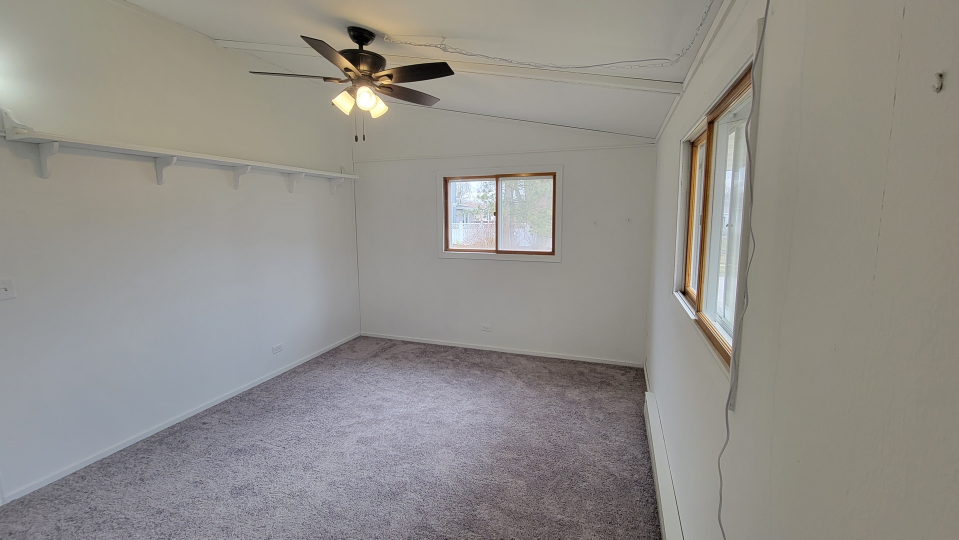 146 Center Street Seneca, IL 61360 - Photo 10 of 19 an empty room with a window and a ceiling fan
