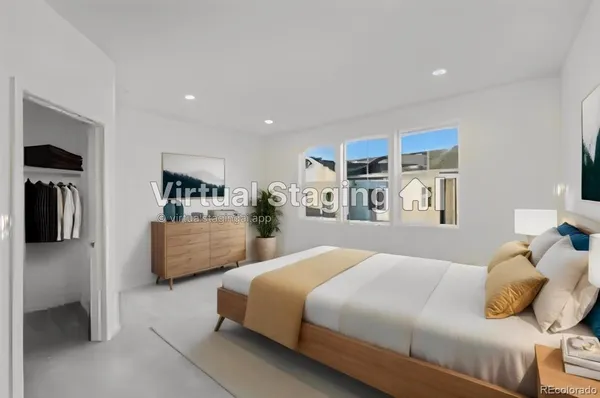a bedroom with a bed and a refrigerator
