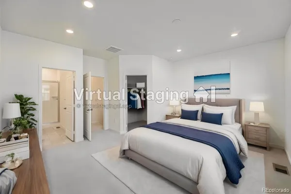 a bedroom with a large bed and a chandelier