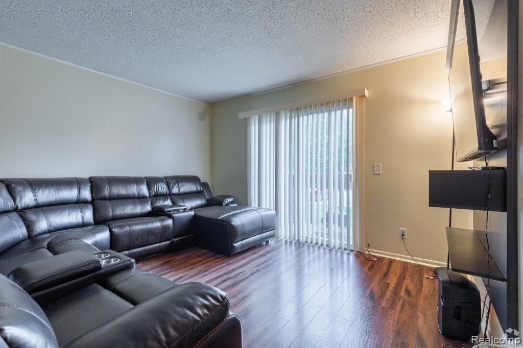 35775 Union Lake Road Clinton Township, MI 48035 - Photo 18 of 30 Living room with a textured ceiling and wood finished floors