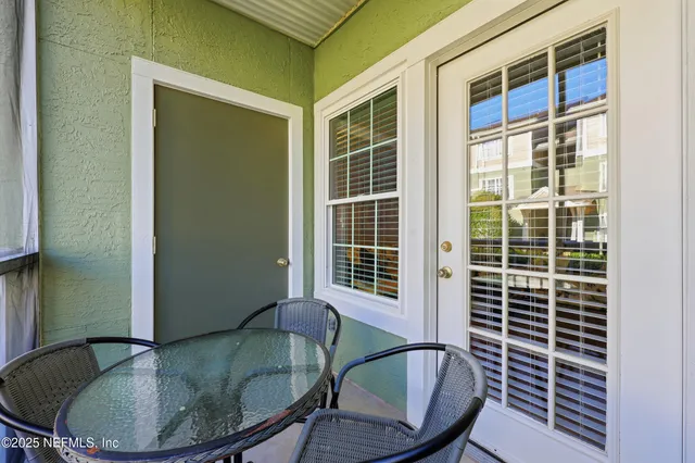 a view of a dining room with a table and chairs