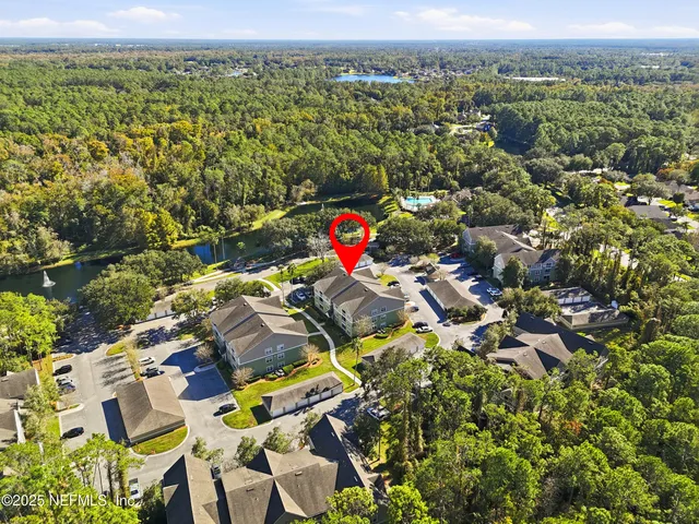 an aerial view of residential houses with outdoor space and swimming pool