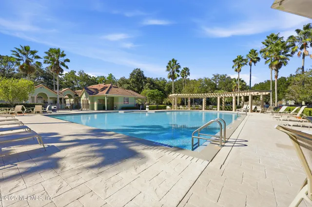 a view of a swimming pool with a lounge chair