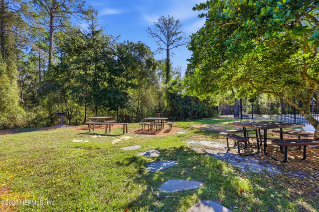 a view of a swimming pool with a table and chairs