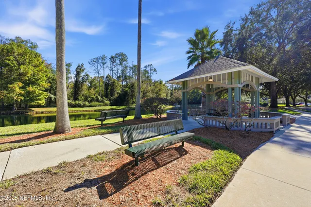 a view of a patio with a table chairs and a small yard