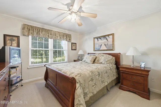 a spacious bedroom with a bed and a flat screen tv