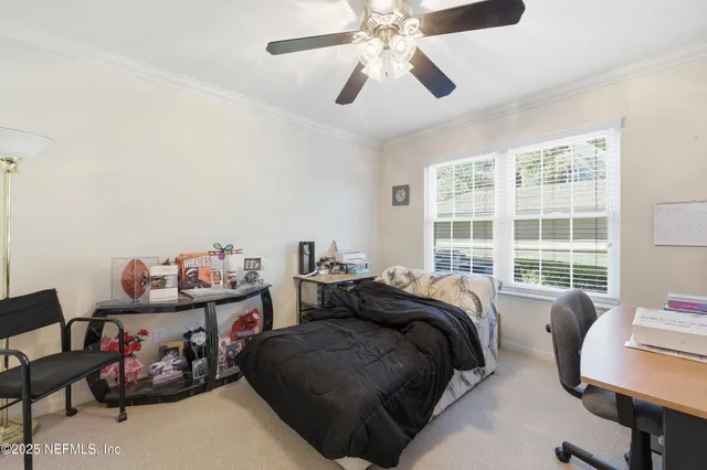 a bedroom with bed and a window