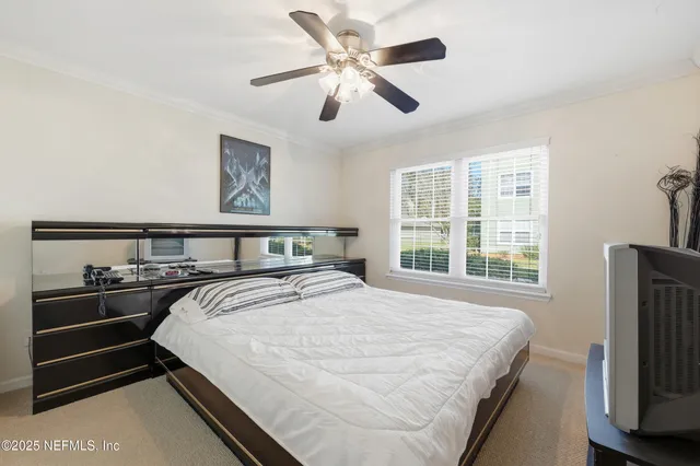 a bedroom with bed and wooden floor