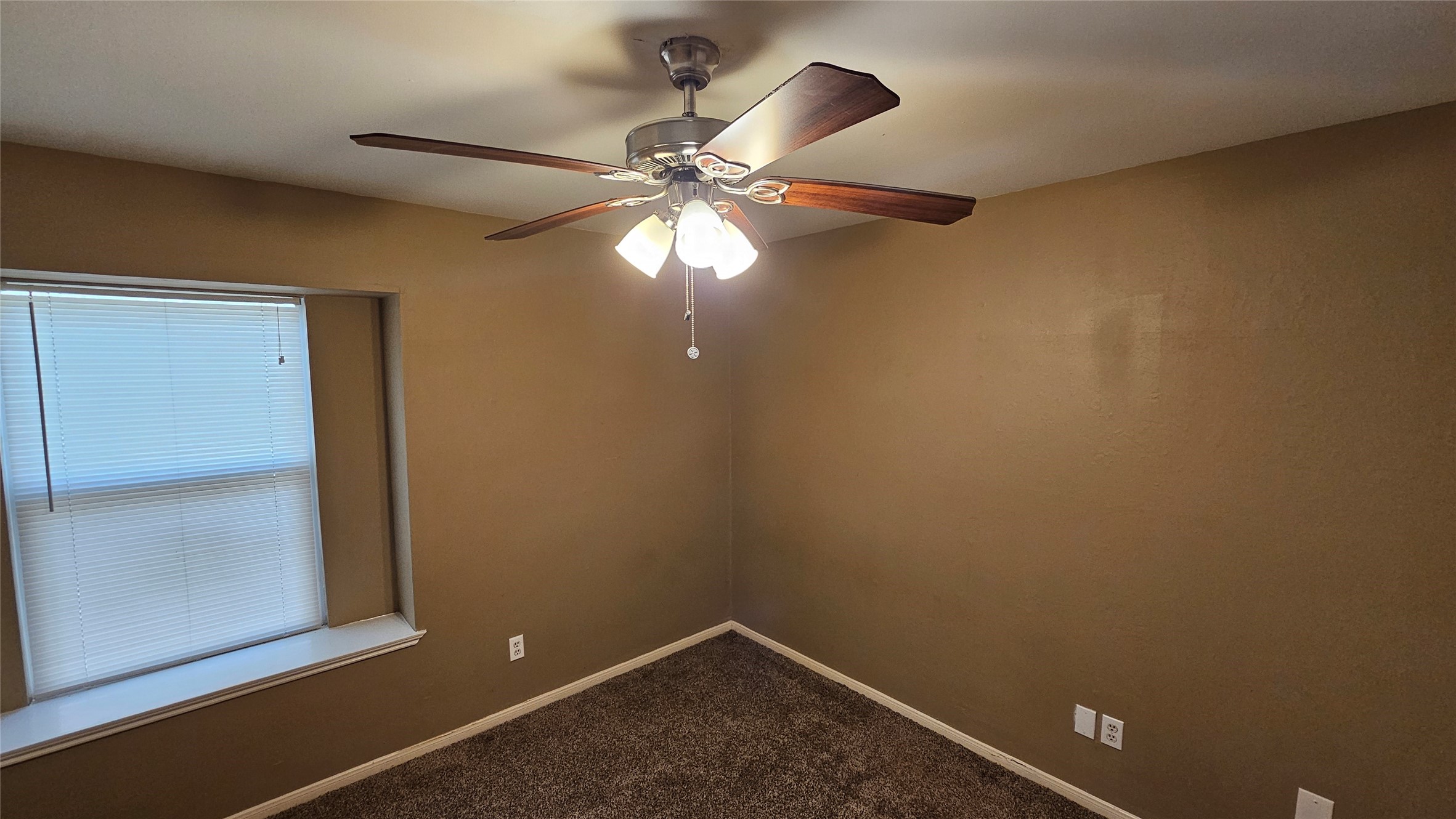 14807 Spring Lake Drive Houston, TX 77070 - Photo 14 of 21 an empty room with windows and fan