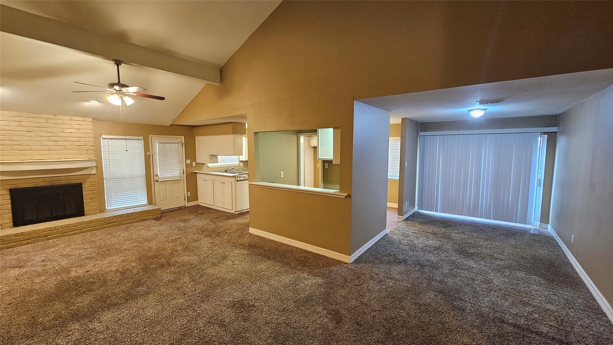 14807 Spring Lake Drive Houston, TX 77070 - Photo 4 of 21 an empty room with windows and fireplace