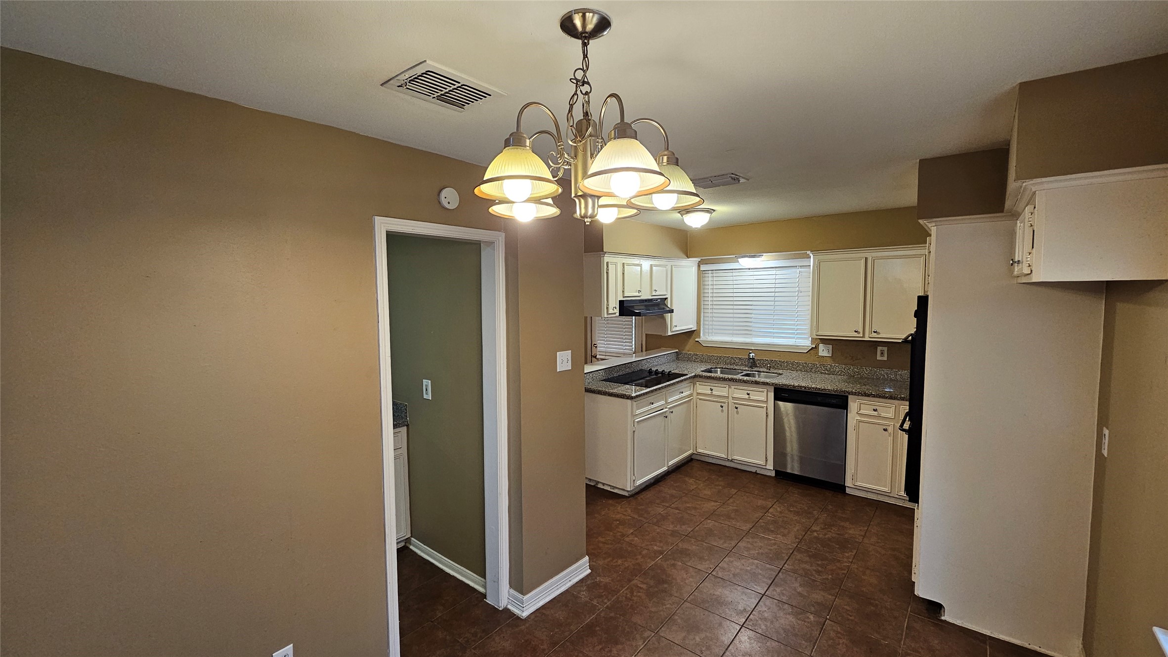 14807 Spring Lake Drive Houston, TX 77070 - Photo 6 of 21 a kitchen with stainless steel appliances granite countertop a sink a stove a refrigerator and a window