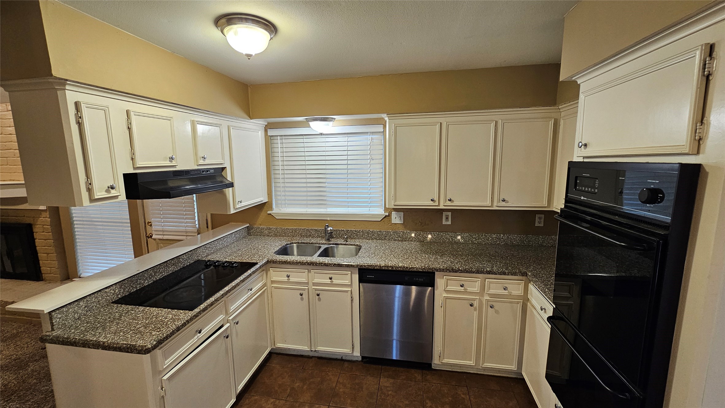 14807 Spring Lake Drive Houston, TX 77070 - Photo 7 of 21 a kitchen with granite countertop a sink stove and microwave