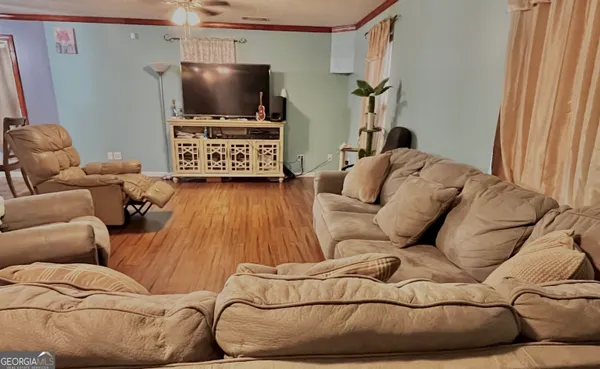 a living room with furniture and a flat screen tv