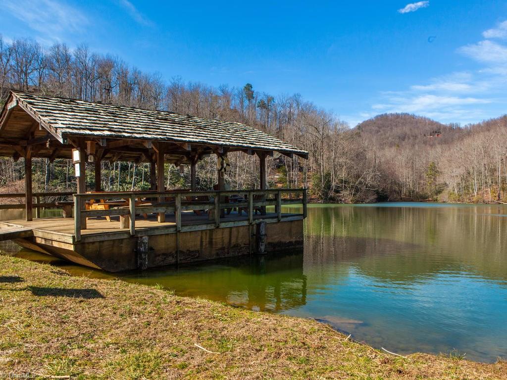 962-963 Bat Cave Road Old Fort, NC 28762 - Photo 11 of 15 Covered dock with patio tables & seating overlooking the lake