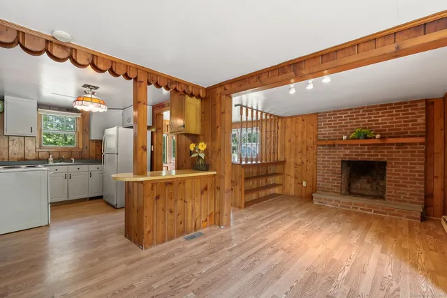 a view of a kitchen with furniture and wooden floor
