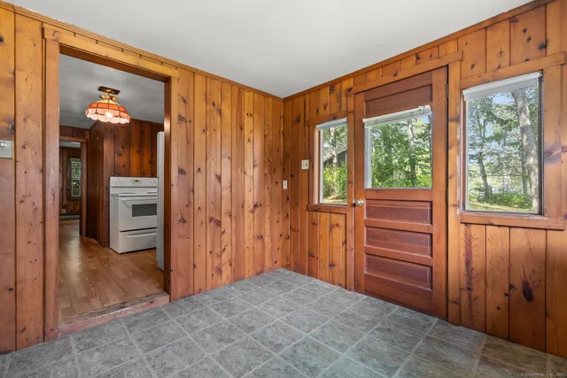 a view of a hallway with wooden cabinets and entryway