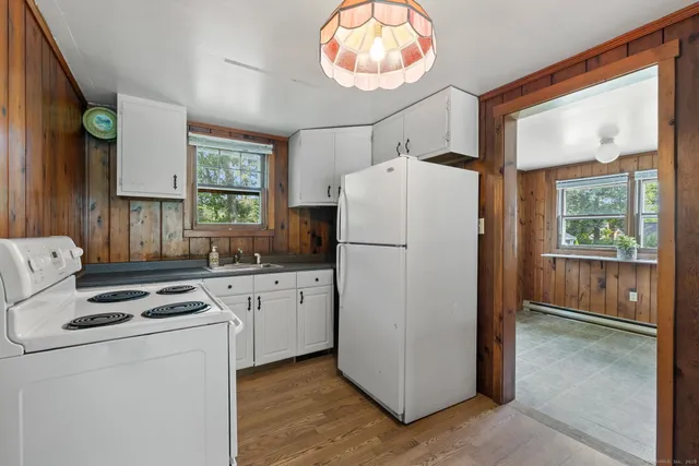 a kitchen with refrigerator a stove a washer and dryer
