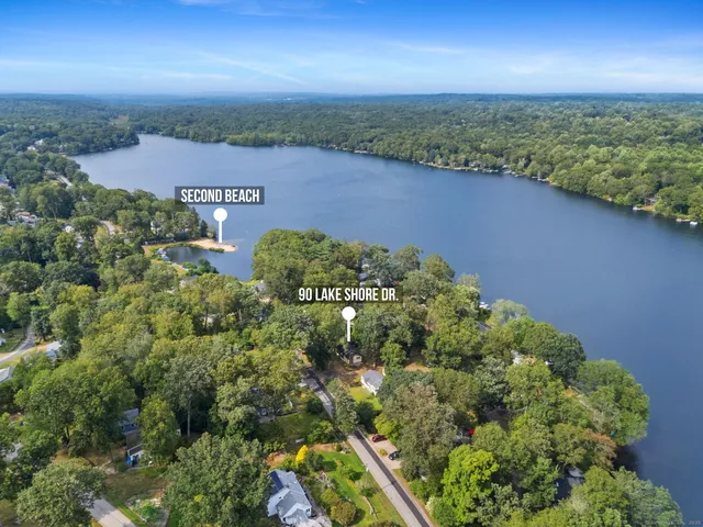 an aerial view of a house with a lake view