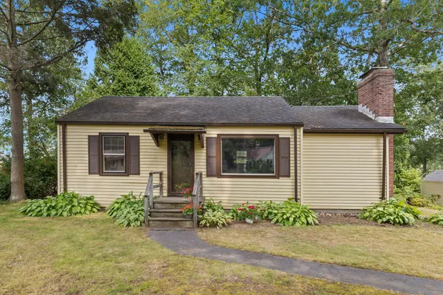 a front view of a house with garden