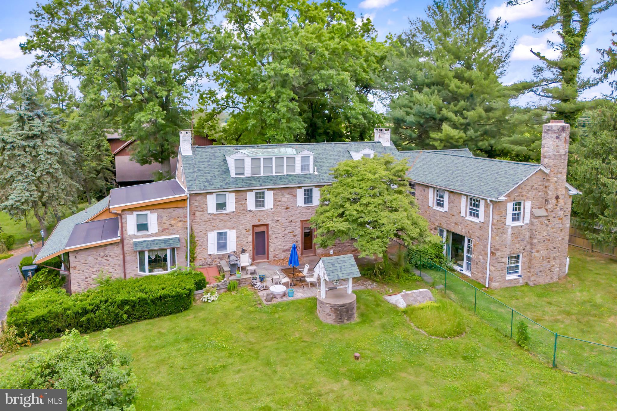 636 Almshouse Road Ivyland, PA 18974 - Photo 1 of 90 a view of a brick building next to a big yard and large trees