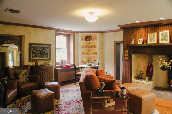 a view of a dining room with furniture a chandelier and wooden floor