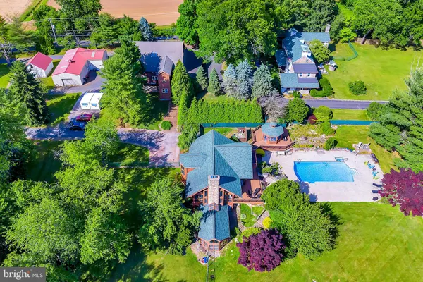 an aerial view of residential house with outdoor space and swimming pool