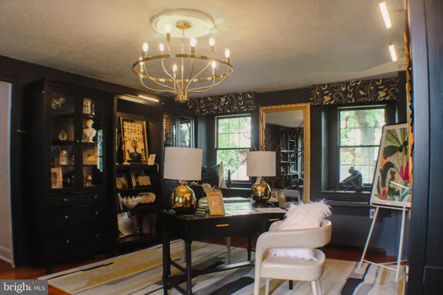 a bedroom with two beds and a chair