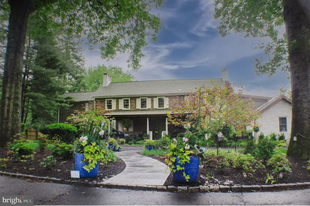front view of a house with a bench