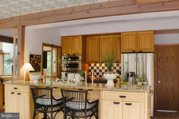 a view of a bathroom with mirror and shower