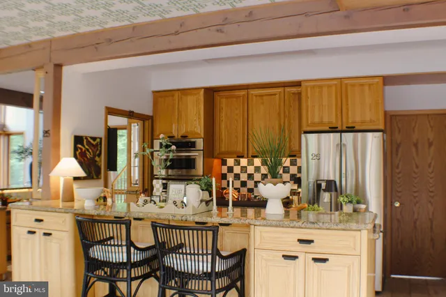 a view of a bathroom with mirror and shower