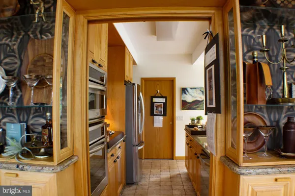 a view of a hallway with furniture and front door