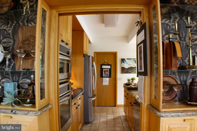 a view of a hallway with furniture and front door