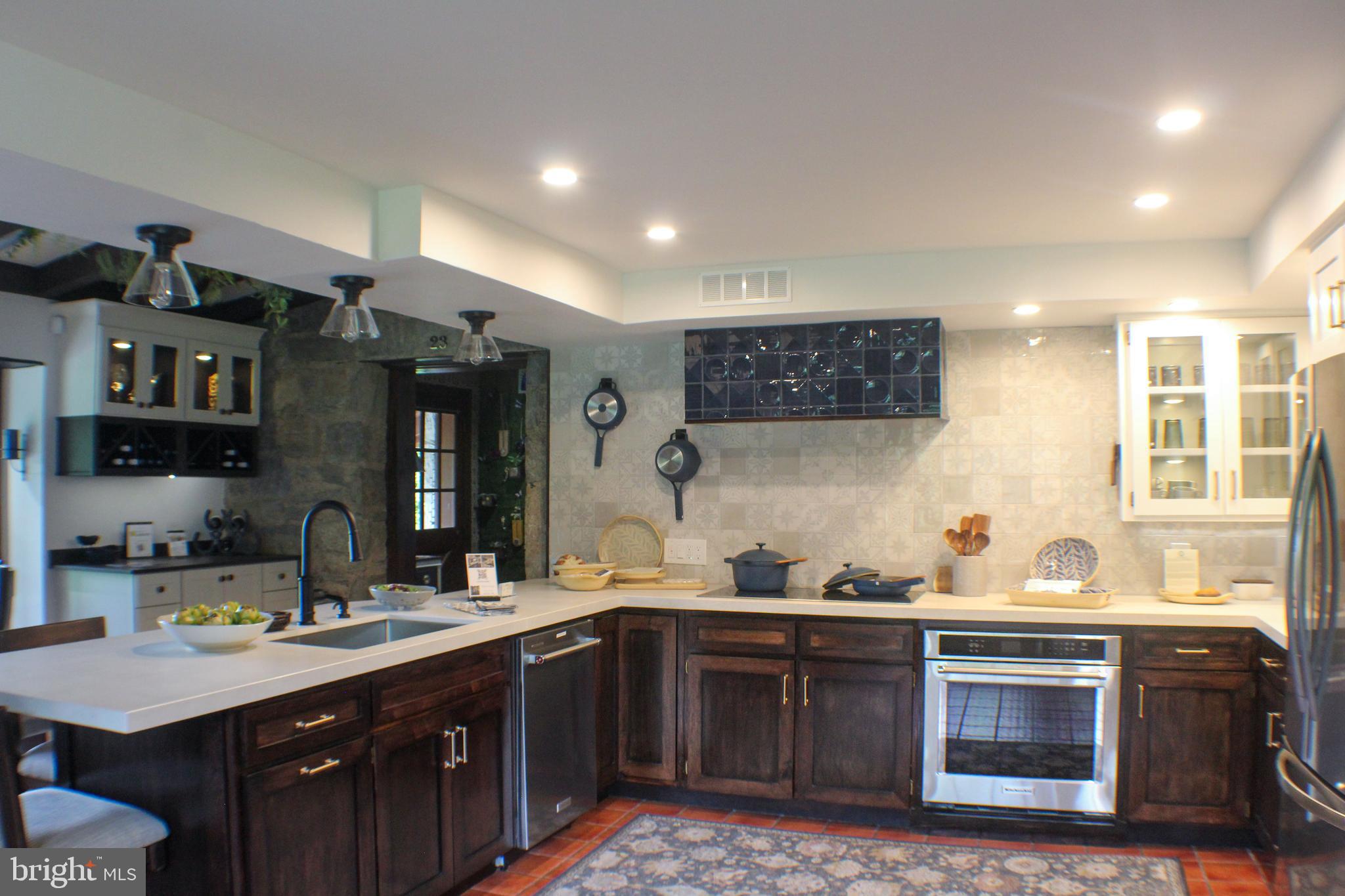 636 Almshouse Road Ivyland, PA 18974 - Photo 4 of 90 a kitchen with stainless steel appliances granite countertop a sink stove and cabinets